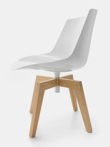 A white Flow Chair Iroko with four-legged in natural oak on a white room background.