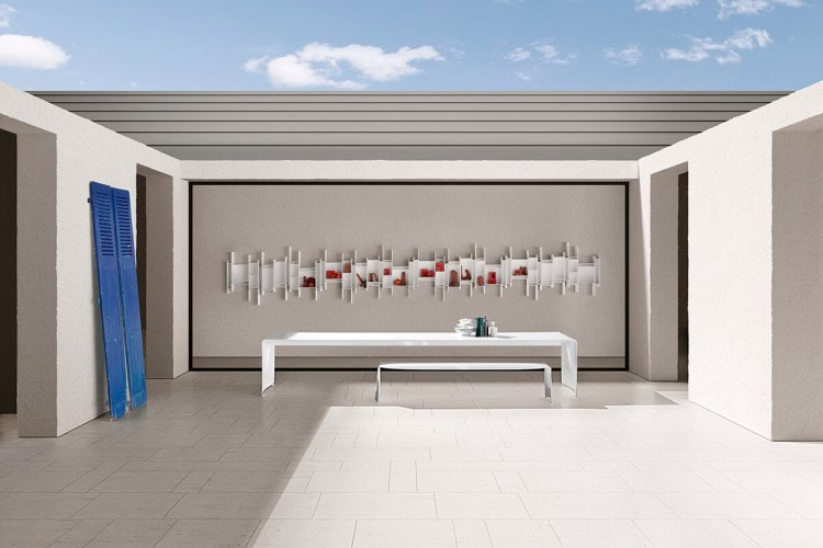 Two La Grande Tables made with a curved aluminium sheet. Finish in gloss white lacquered on a outdoor background.
