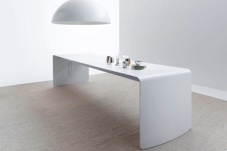 One La Grande Table made with a curved aluminium sheet. Finish in gloss white lacquered on a dining room background.