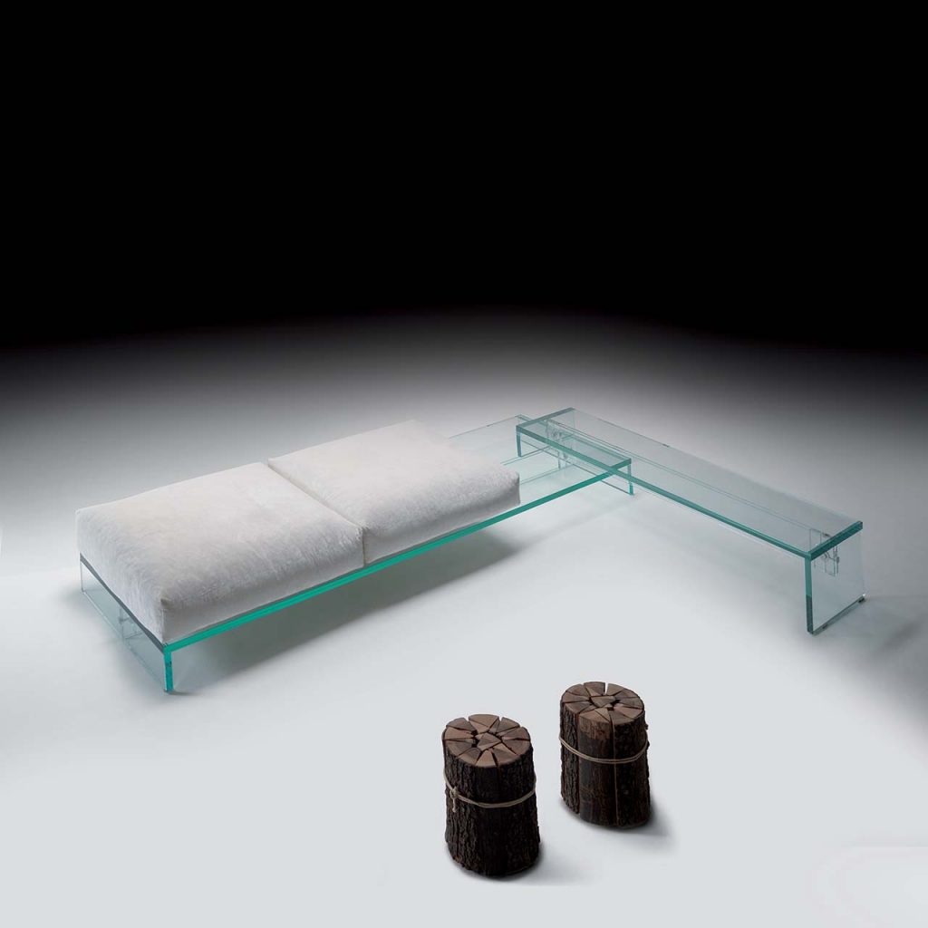 Simplicity Bench in transparent glass with a sleek modern design, featuring a floating effect and a cushioned seat for comfort in contemporary spaces