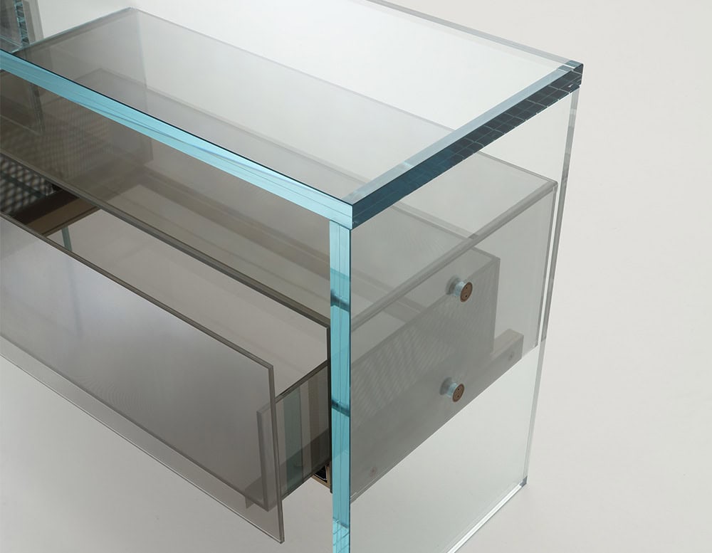 A detailed view of the Simplicity Sideboard, showcasing its transparent glass structure with integrated storage drawers, combining modern elegance with functional design