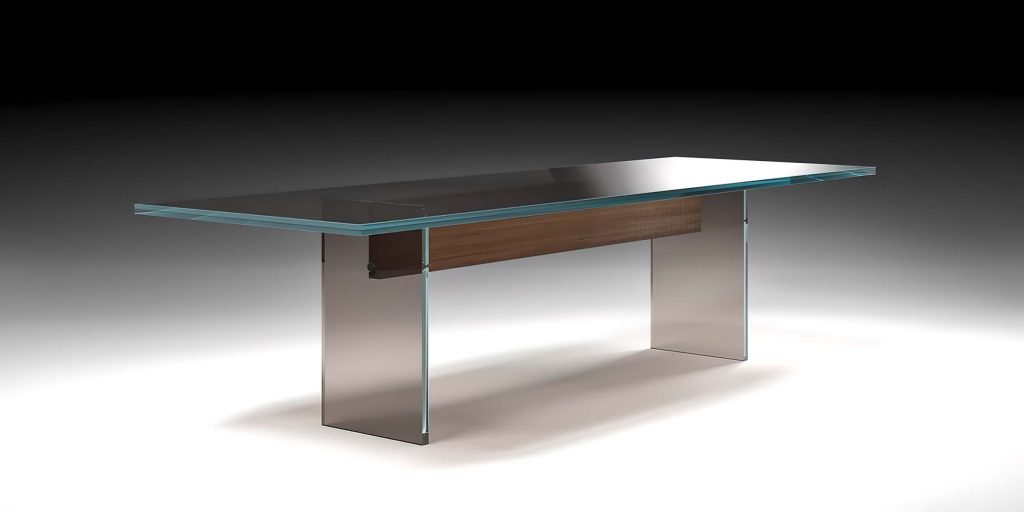 A sleek, modern glass coffee table with a sculptural, minimalist design. Its thick, transparent structure gives a floating effect with smooth, clean lines
