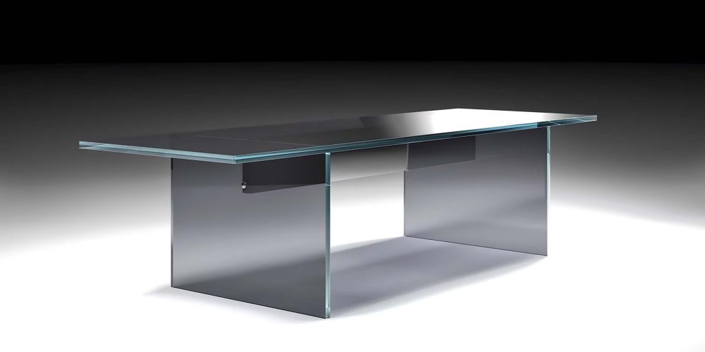 A sleek, modern glass coffee table with a sculptural, minimalist design. Its thick, transparent structure gives a floating effect with smooth, clean lines