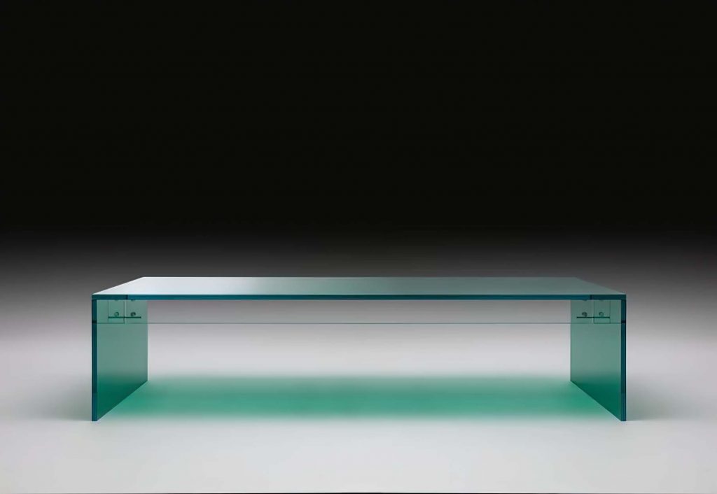 A contemporary rectangular glass coffee table with a minimalist design, featuring a thick transparent glass top and sides, creating a sleek floating effect