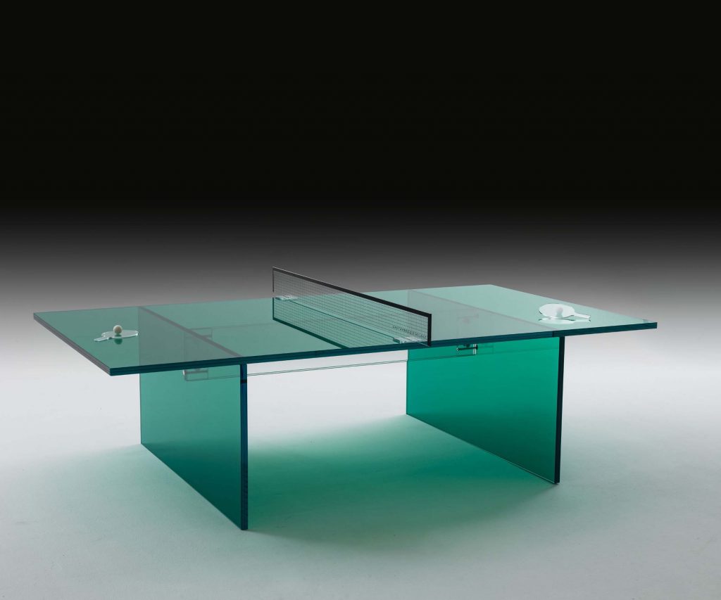 A sleek modern glass coffee table with a geometric design, featuring intersecting transparent glass panels in a minimalist style with a reflective finish