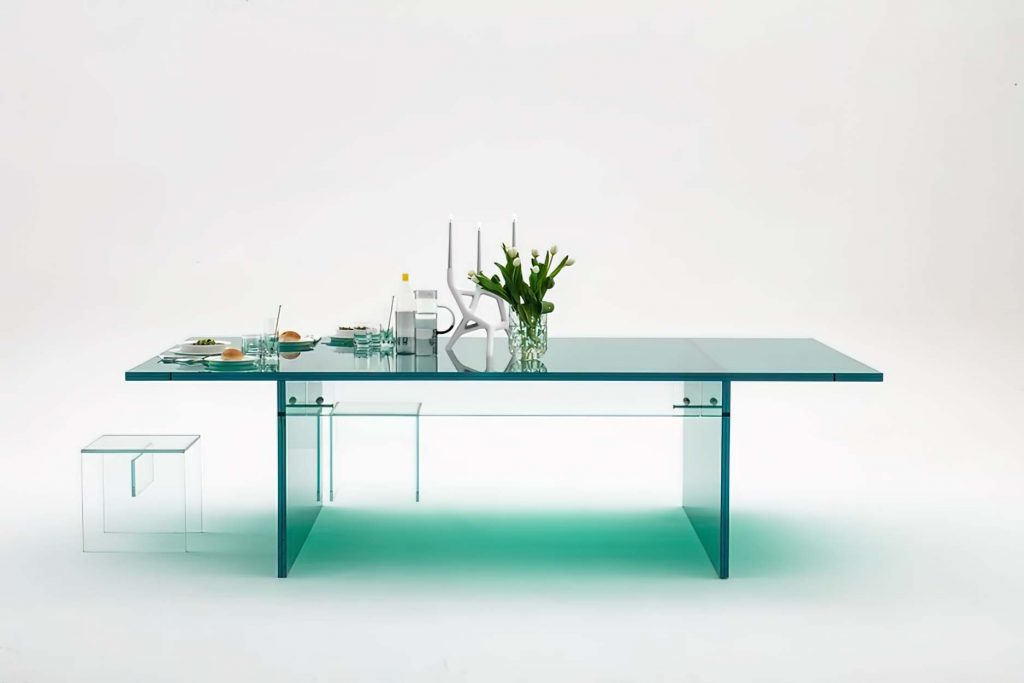 A stunning modern glass dining table with a transparent design, featuring a sleek minimalist aesthetic with a sturdy glass base and spacious tabletop