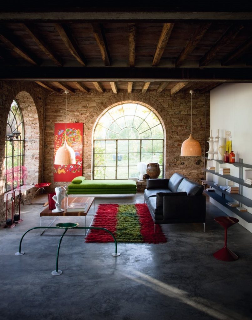 Allunaggio stool with a round green seat and three metal legs in a living room.