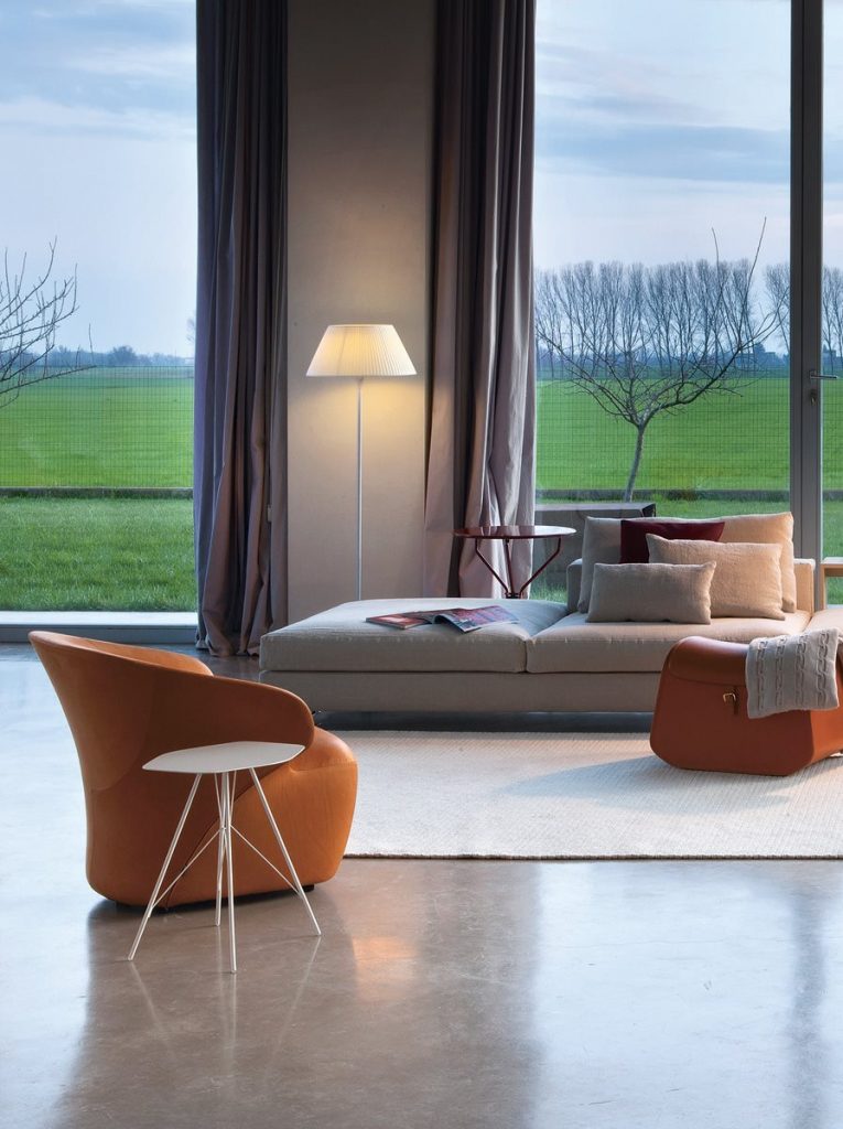 Two Arom armchairs upholstered in brown fabric in a living room.