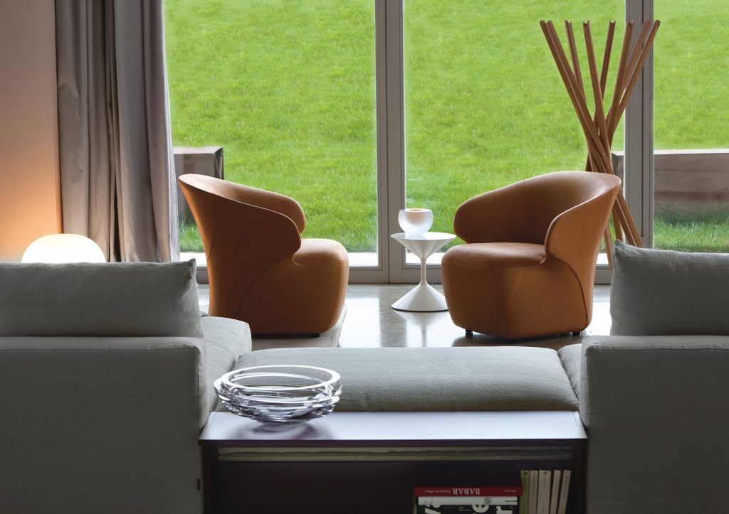 Two Arom armchairs upholstered in brown fabric in a living room.