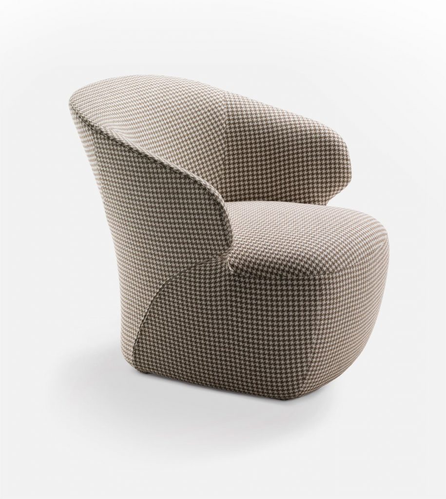 Arom armchair upholstered in gray fabric on a gray background.