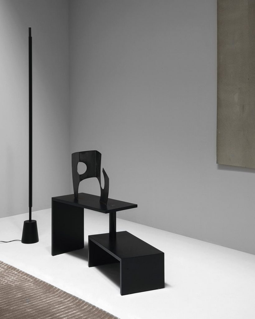Black rectangle Basello side table. It consists of two tables joined by a round stick on a white background.