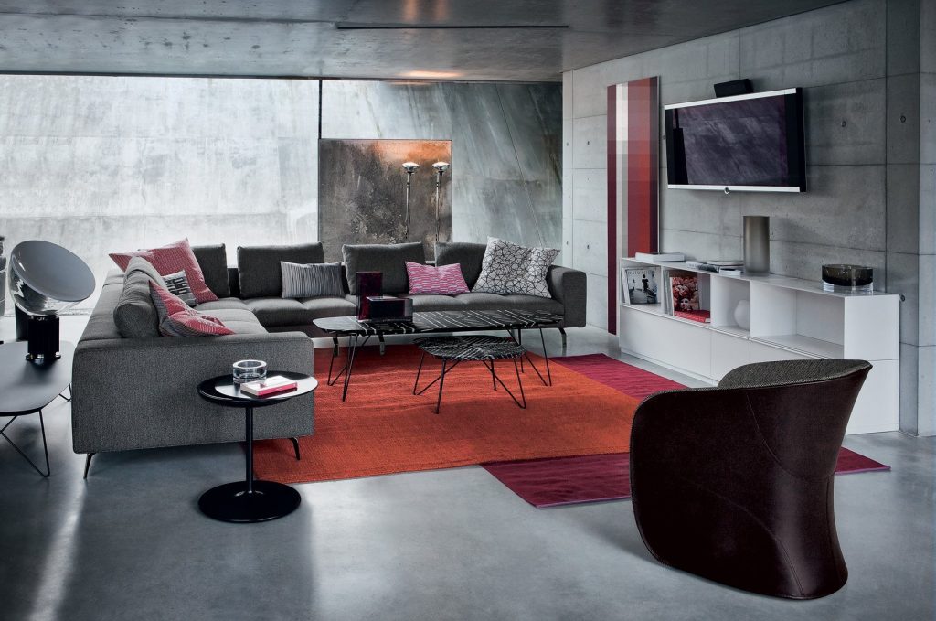 Calla armchair upholstered in brown fabric in a living room.