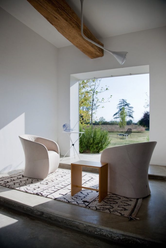 Two Calla armchairs upholstered in white fabric in a living room.
