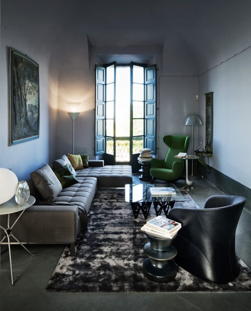 Calla armchair upholstered in black fabric in a living room.
