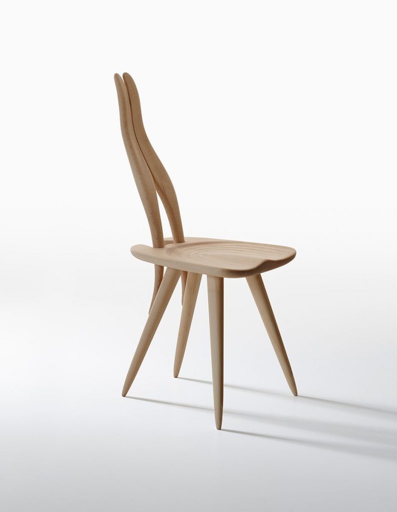 Fenis chair with a natural wooden frame, rabbit ears like shape back on a white background.