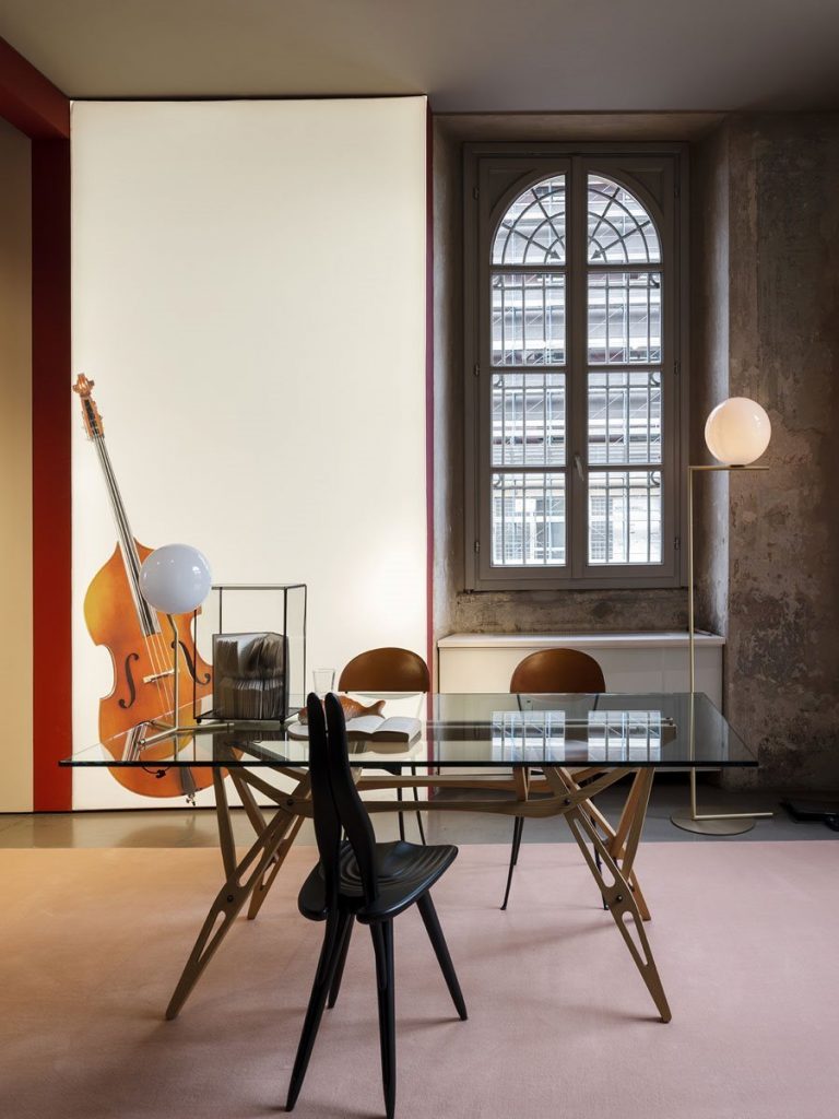 Fenis chair with a black frame, rabbit ears like shape back in a office.