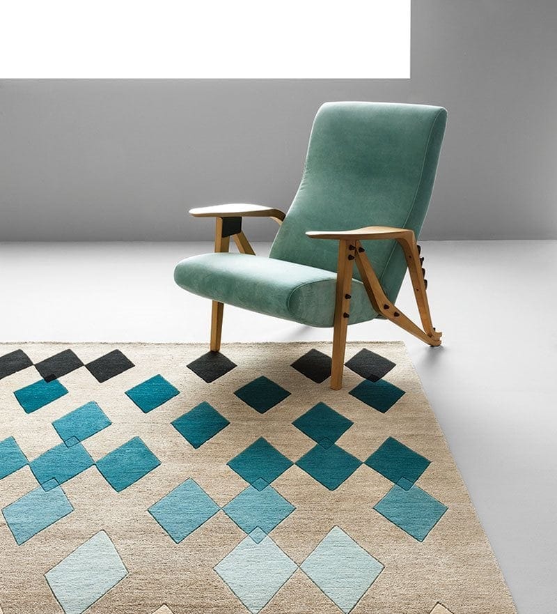 Gilda chair with a wooden frame and a blue upholstered seat and backrest on a white background.