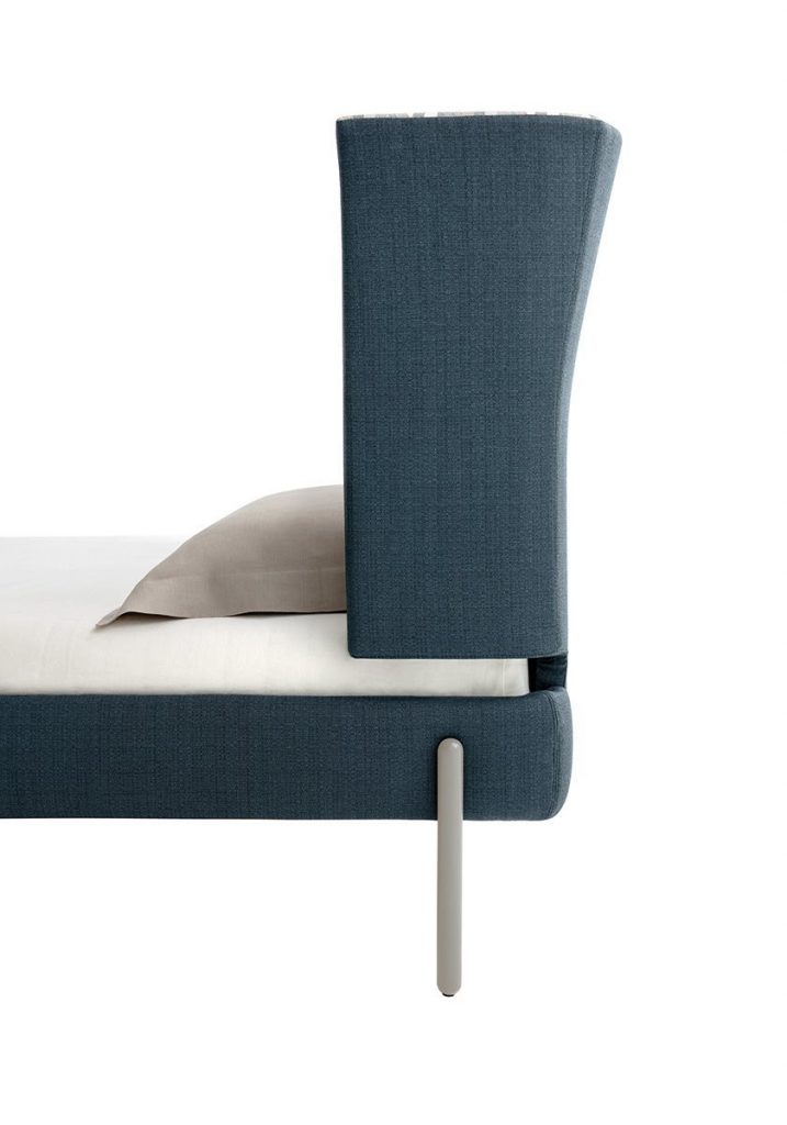 Greta bed with headboard upholstered in blue fabric flower pattern with four silver steel legs on a white background.