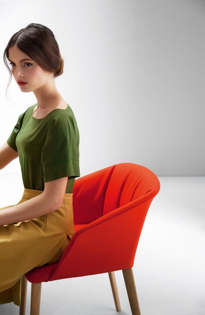 Liza 2271 - 2271R chair featuring a red cushioned seat, armrest and backrest with four natural wood legs in a dining room.