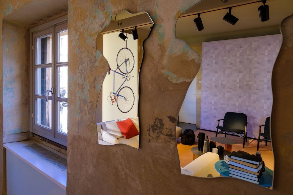 Two Milo mirrors in the shape of the torso of the human body on a wall.