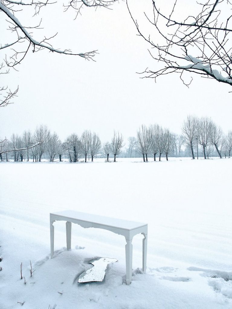 Milo mirror in the shape of the torso of the human body in the snow.