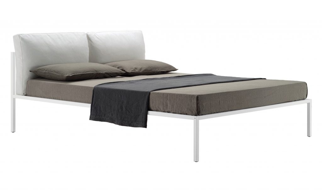 Nyx bed featuring a padded headboard and white frame and four legs on a white background.