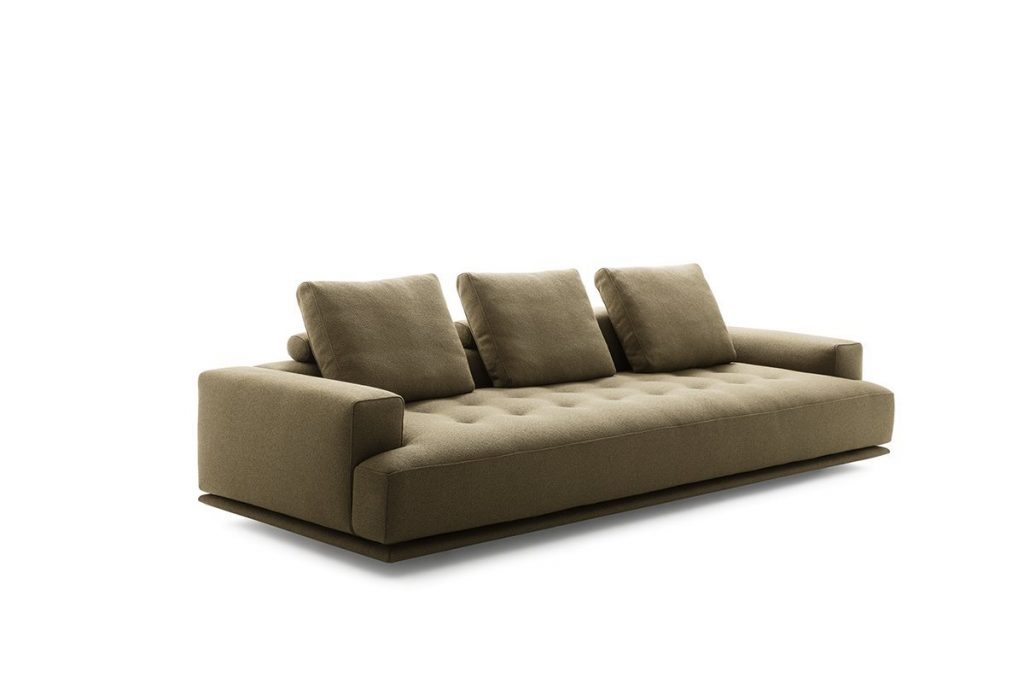 Shiki sofa upholstered in brown with cushions on a white background.