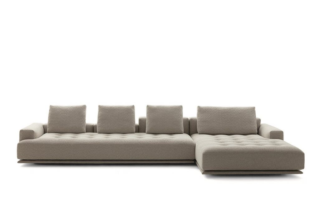 Shiki sofa upholstered in beige with cushions on a white background.