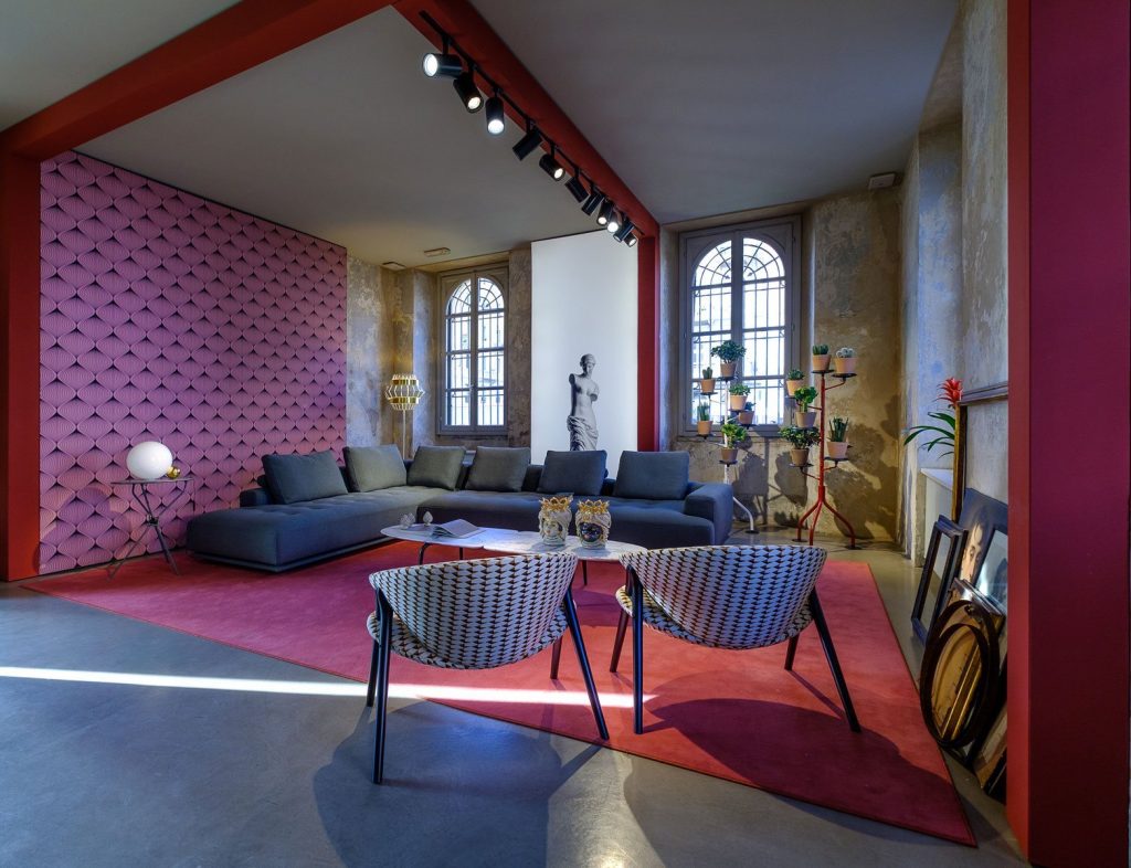 Shiki sofa upholstered in blue with cushions in a living room.