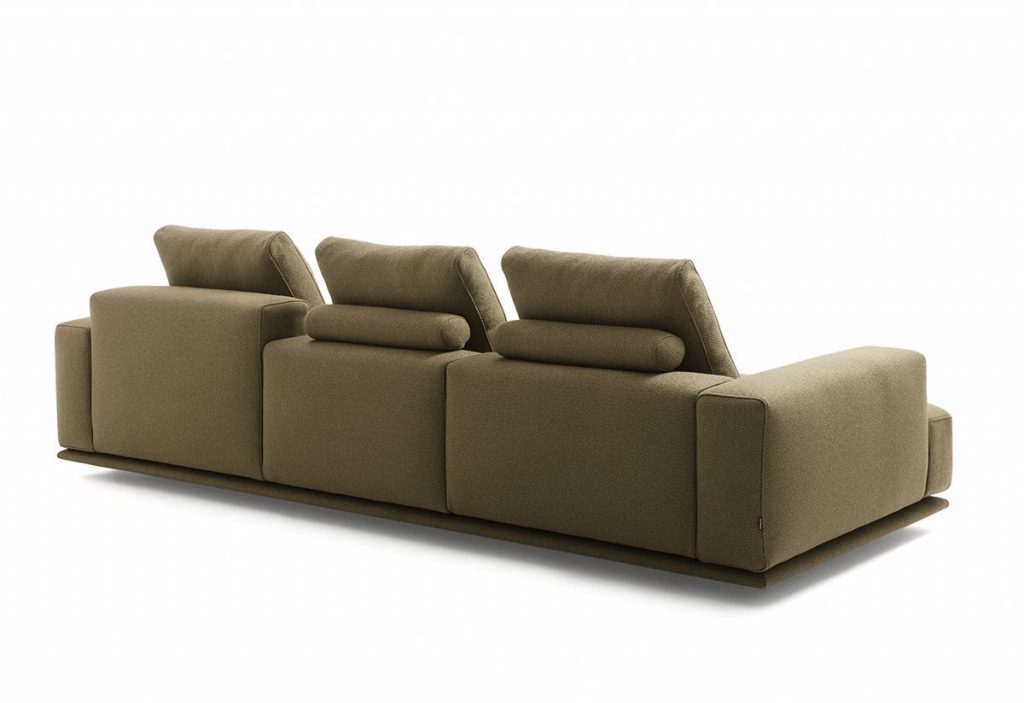 Shiki sofa upholstered in brown with cushions on a white background.