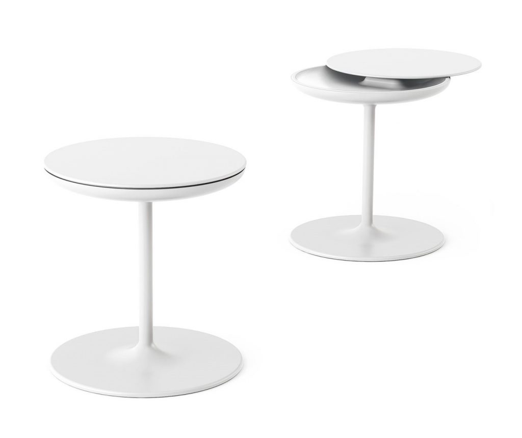 Two Toi side tables with a round white top and central leg, in a living room.