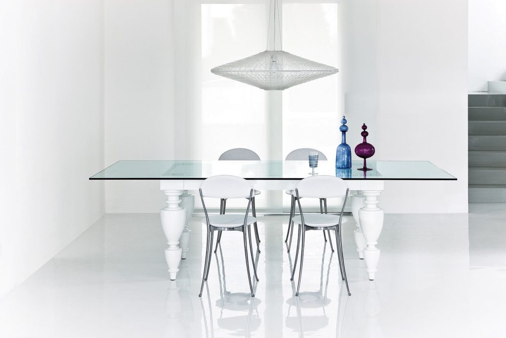 Four Tonietta chairs featuring a white cushioned seat and backrest, and black metal frame in a dining room.