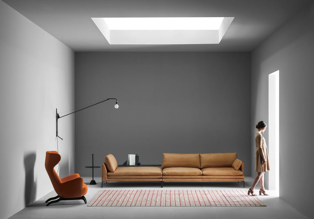 William sofa with a minimalist design, light brown upholstery, and slim metal legs in a living room.