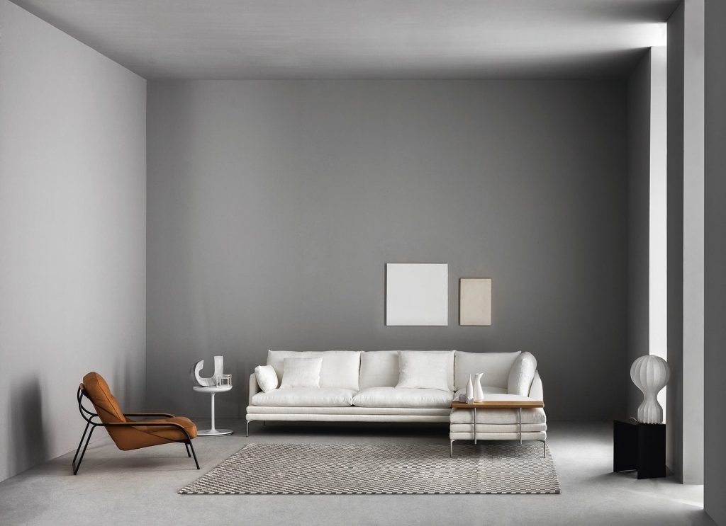 William sofa with a minimalist design, light gray upholstery, and slim metal legs in a living room.