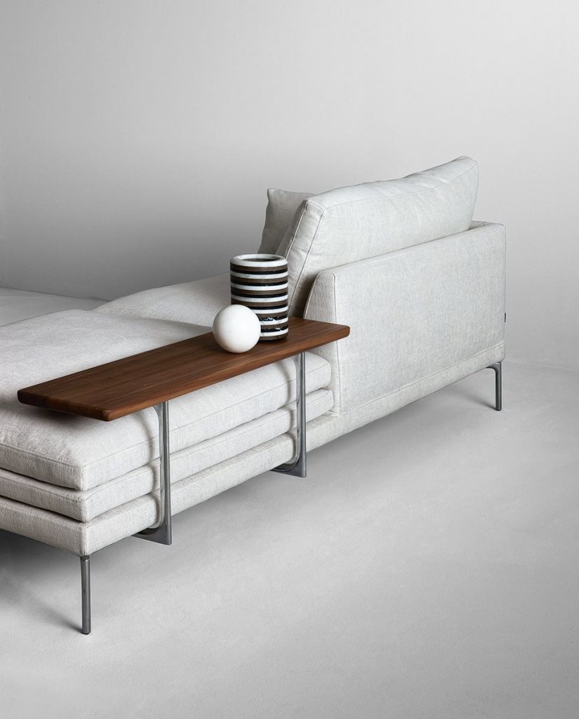 William sofa with a minimalist design, light gray upholstery, and slim metal legs on a white background.