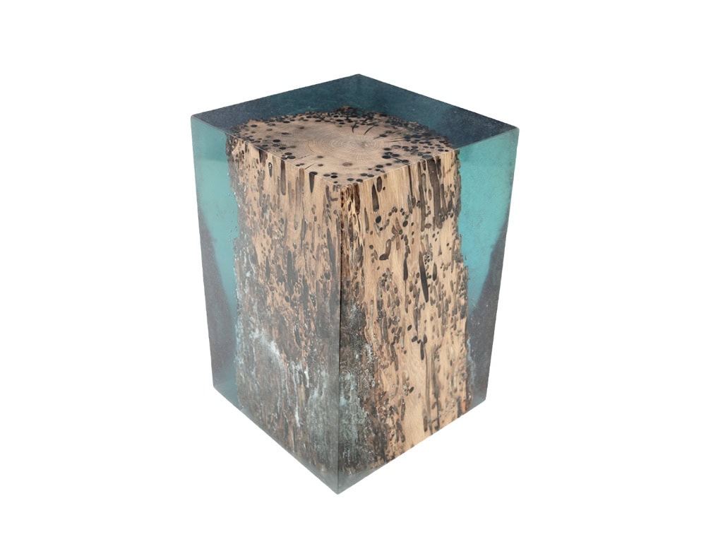 A captivating stool where natural wood encased in transparent resin evokes the sensation of wood floating underwater. Its organic textures and clear finish highlight nature’s raw beauty in a functional design.