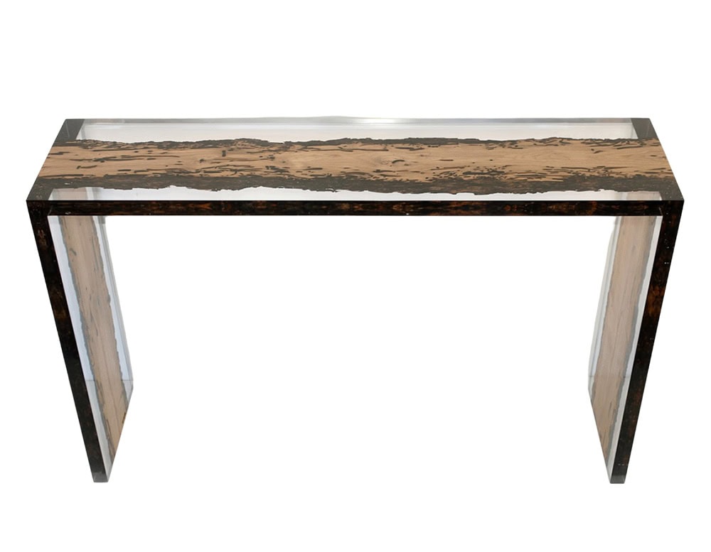 A modern console table combining natural wood with transparent resin for a striking effect. Its clean silhouette and refined finish make it ideal as an entryway or living space statement piece.
