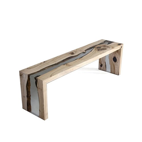 A sleek bench combining natural wood grain with clear resin for a flowing, creek-like effect. Its minimal form emphasizes organic details while providing a modern, functional seating piece.