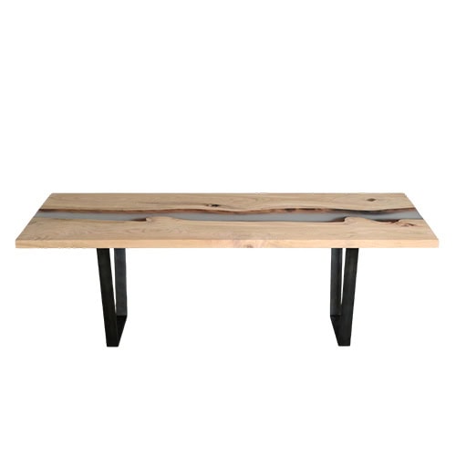 A refined dining table combining natural wood with resin river details and steel legs. Its minimal yet organic design makes it an elegant focal point for contemporary interiors.
