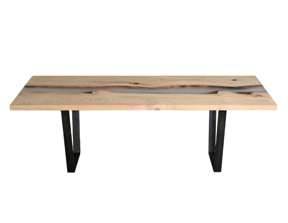 This Creek Table highlights the natural flow of wood grains framed by a clear resin river. Supported by minimalist black steel legs, it combines raw organic texture with modern design for a refined centerpiece.
