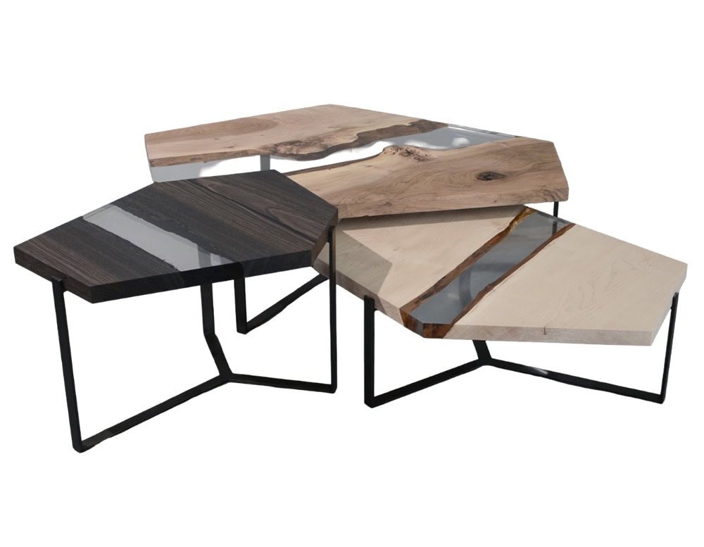 A modular trio of geometric coffee tables crafted from walnut, maple, and peatwood with clear resin inlays and steel bases, offering versatile arrangements and modern elegance.