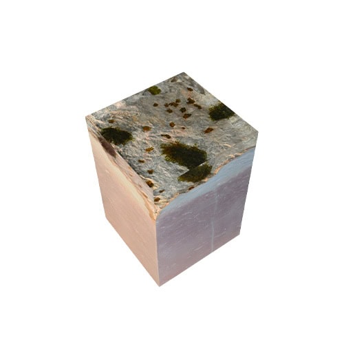 The Dolomyth Stool combines natural stone textures with a polished block form, highlighting raw mineral beauty. Moss-like accents on the top bring a striking organic contrast to its geometric shape.