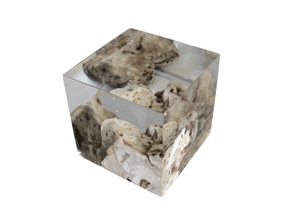 This bookend encapsulates natural karst stone within clear resin, creating a sculptural piece that merges raw texture with modern transparency. Its geometric form makes it both functional and decorative.
