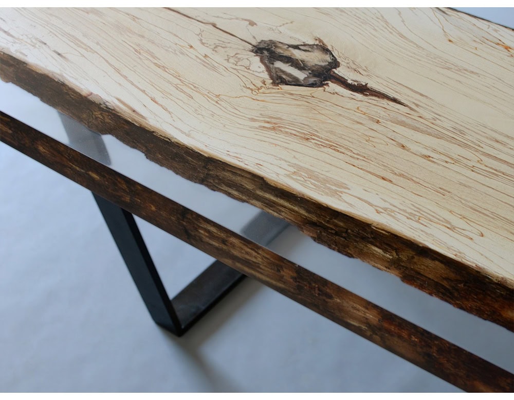 This console table combines natural spalted wood with transparent resin, highlighting organic details within a clean, modern frame. Supported by minimalist legs, it blends rustic texture with sleek design for a refined statement piece.