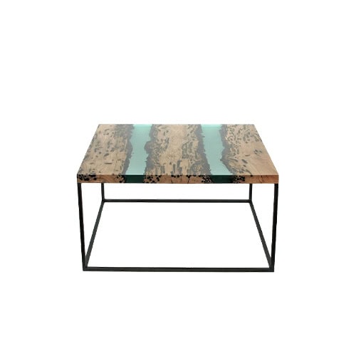 The Jetty Coffee Table combines natural wood with a sleek resin inlay, creating a striking surface supported by a minimalist metal frame. Its balance of organic and modern elements makes it a versatile centerpiece.