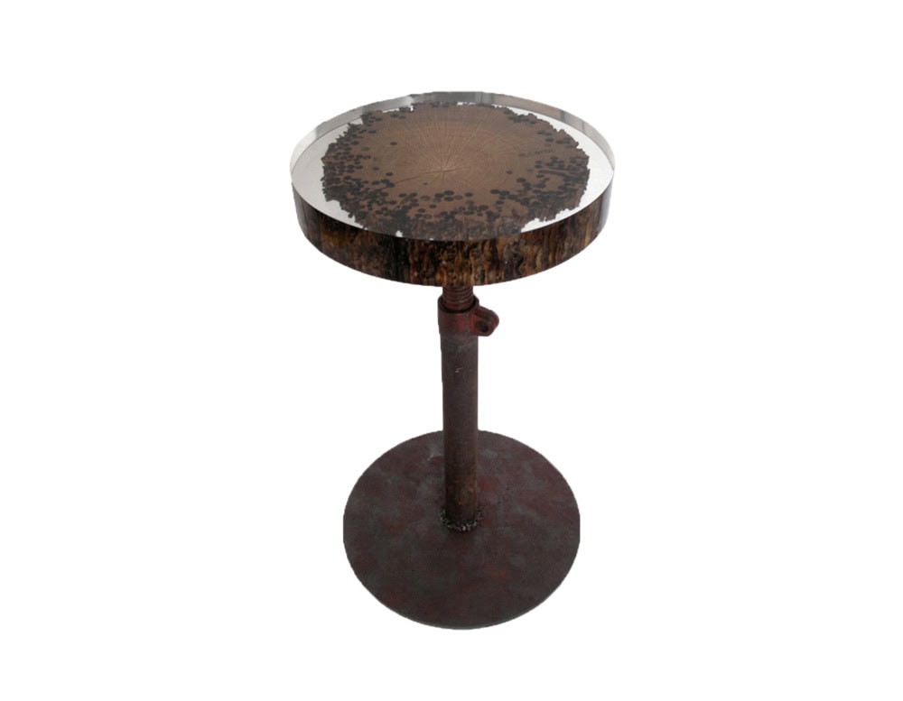 The Mareale Stool combines rustic charm with industrial strength, featuring a preserved wood slice encased in resin and supported by a sturdy metal base. Its round top highlights natural textures with a striking contemporary edge.