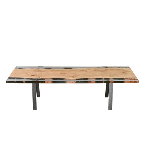 Moss Table displays a wide wooden surface framed by clear resin with subtle moss inclusions. Its natural grain contrasts with sturdy metal legs, offering a contemporary piece that bridges raw nature with modern design.