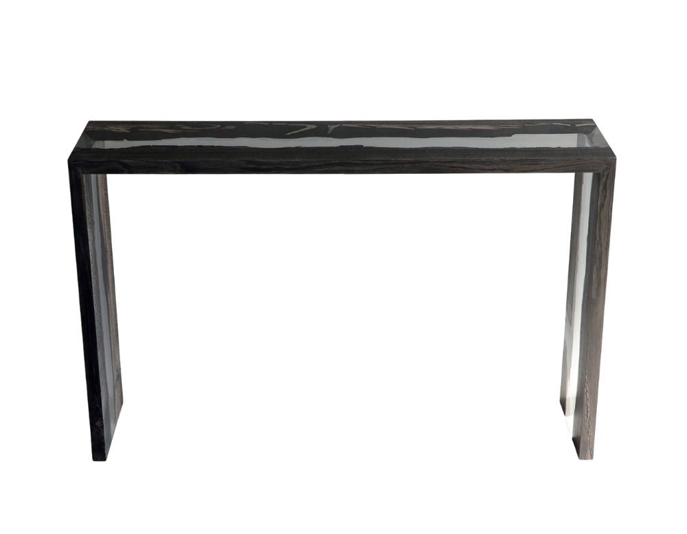 Peatland Console Table frames charred wood in clear resin, forming a sleek rectangular silhouette. Its slim profile and glossy finish create a refined piece that merges raw texture with minimalist design.