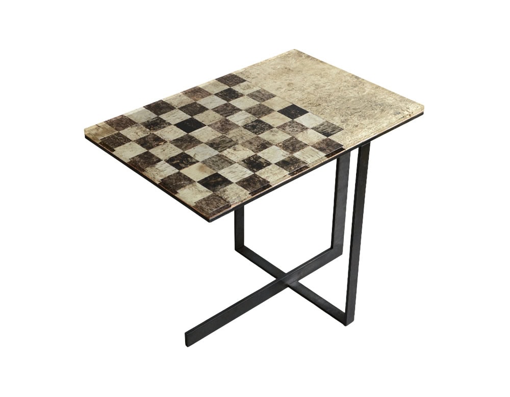 Phellem Chess Table showcases a cork chessboard surface in earthy tones, balanced on slender intersecting legs. Its blend of natural texture and geometric form offers a modern reinterpretation of a classic game table.