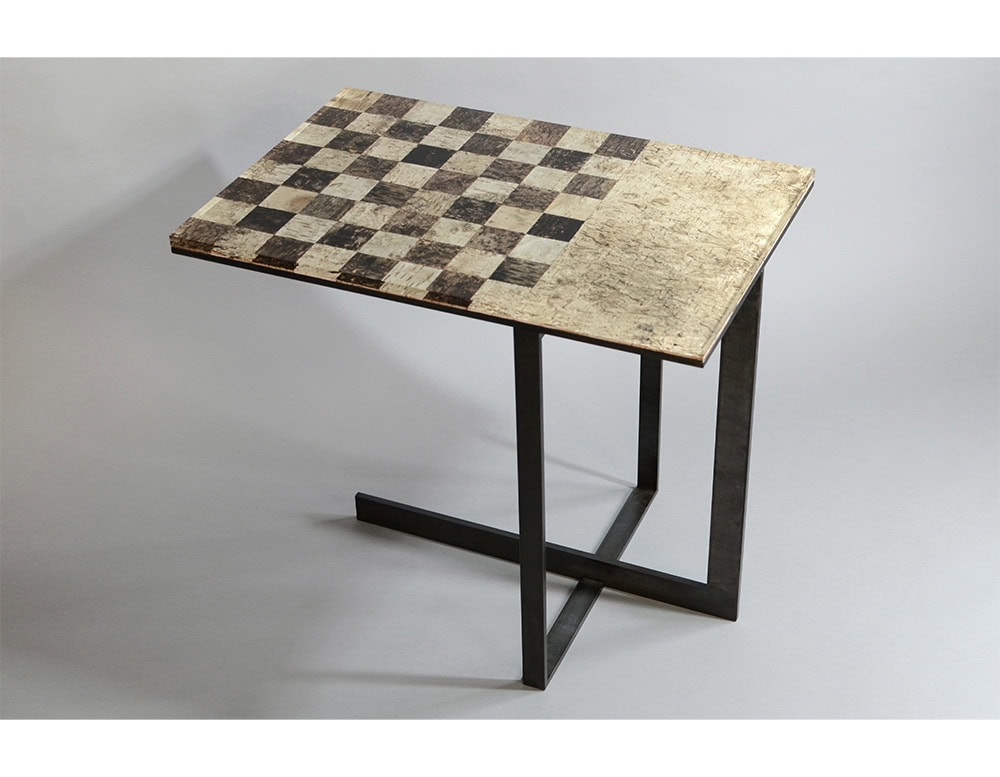 Phellem Chess Table combines a cork chessboard top with a raw textured surface, set on slim metal legs. Its mix of natural patterns and minimal structure creates a functional and artistic piece.